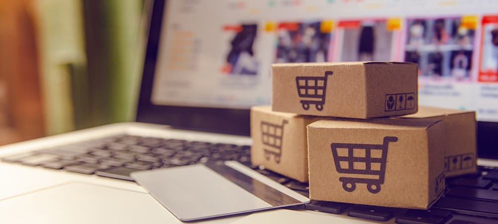 Shopping online concept - Shopping service on The online web. with payment by credit card and offers home delivery. parcel or Paper cartons with a shopping cart logo on a laptop keyboard